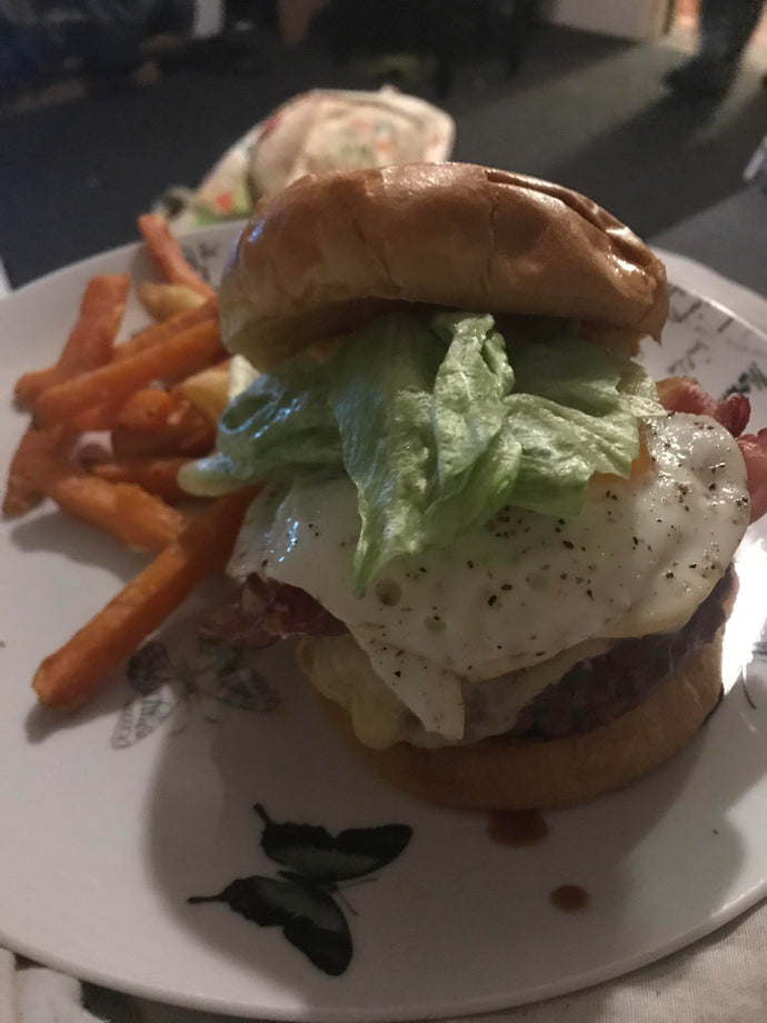 Egg, bacon cheese burger with sweet potato fries