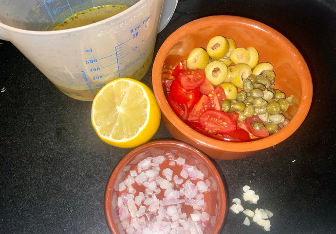 Marinated Sea Bass Fillets with a Tomato, Olive and Caper Sauce