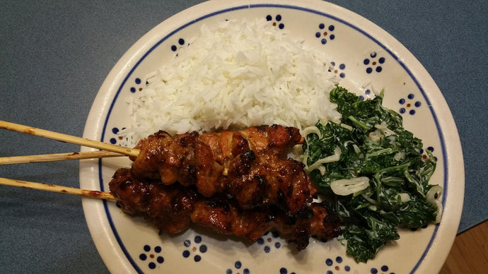 Pork Satay with rice and greens in coconut cream.