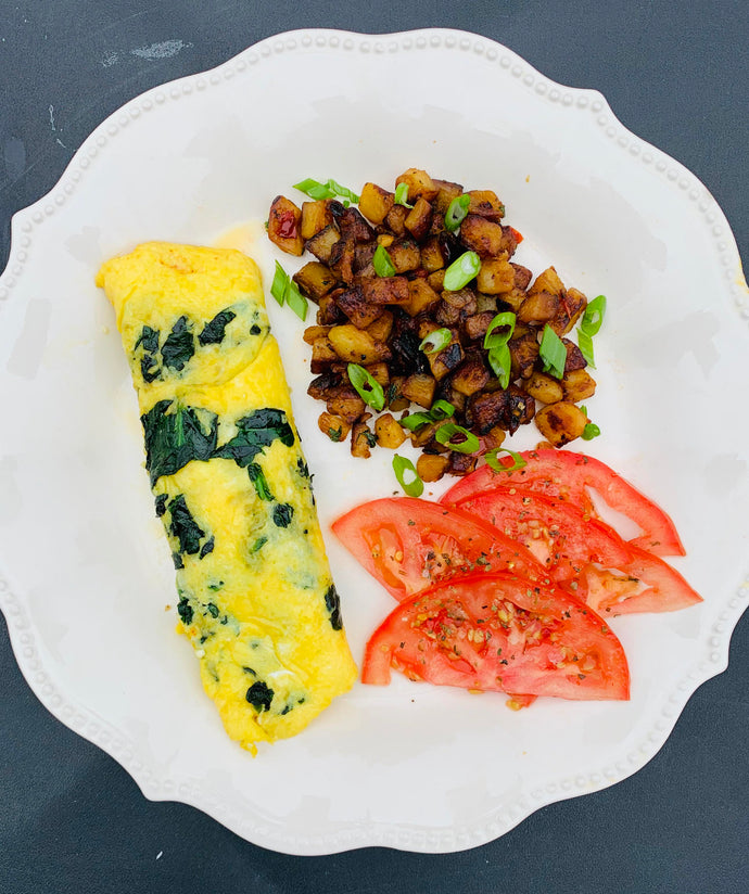 spinach and feta omelet, potato and pepper hash, and sliced tomatoes with oil and vinegar
