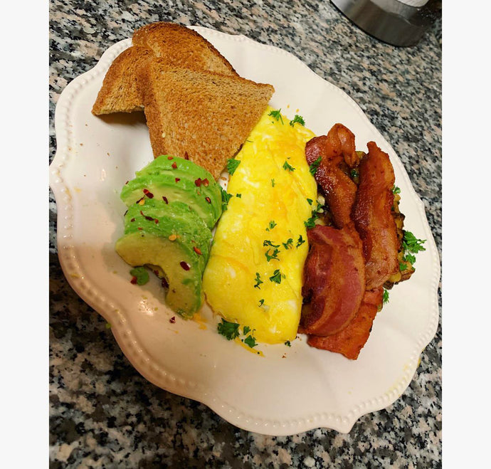 Brinner. Cheese Omelette, avocado toast, Bacon, and an unhealthy amount of breakfast potatoes hidden by said bacon.