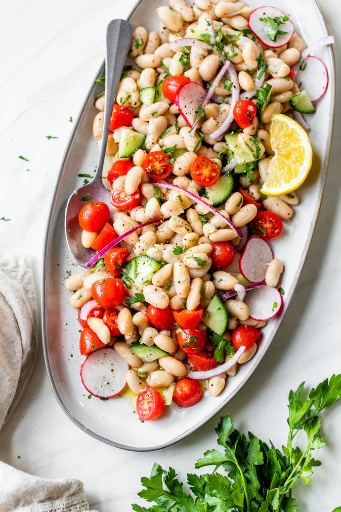 This Cannellini Bean Salad is the ultimate spring and summertime recipe! It's made with cannellini beans (aka white kidney beans), tomatoes, cucumbers, and onion, and drizzled with a simple lemon dressing
