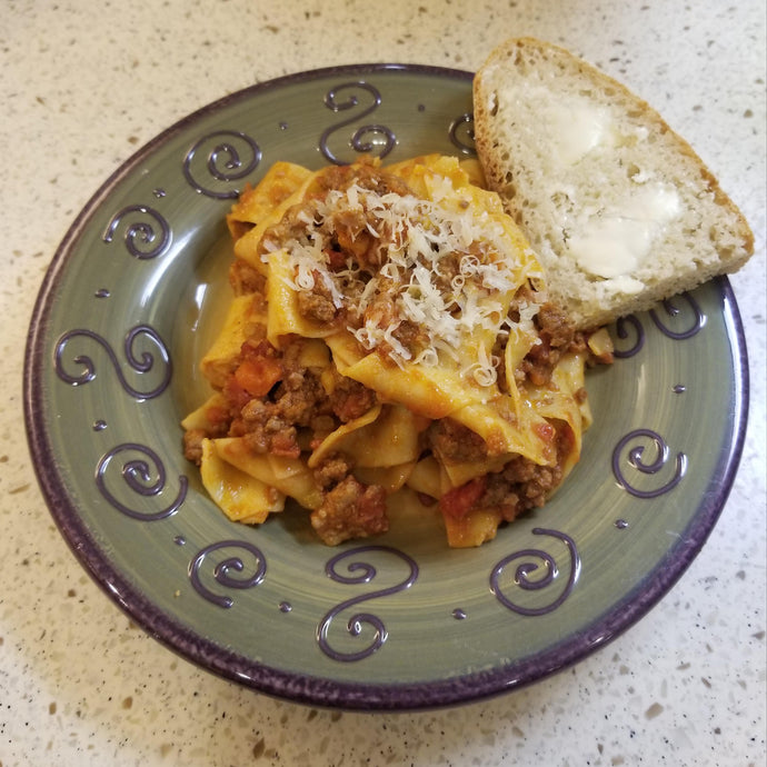 Homemade bolognese with pappardelle and homemade no knead Dutch oven bread