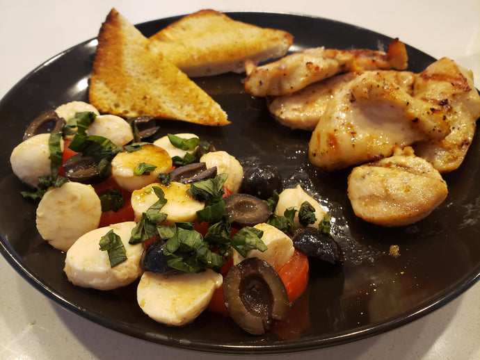 Italian marinated grilled chicken, caprese salad and a toasted ciabatta roll.